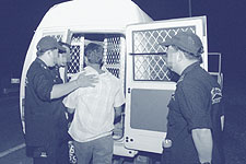 Suspect being placed in van