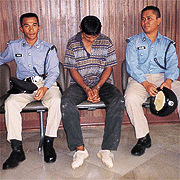 Daud accompanied by two police officers