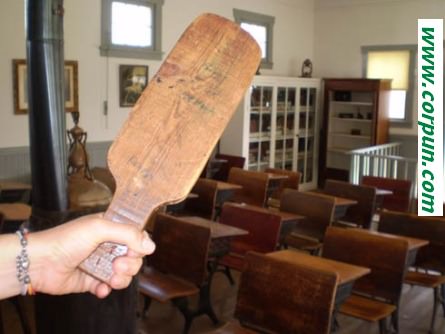 Old=fashioned paddle in teacher's hand