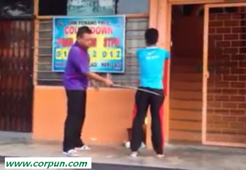 Schoolboy being caned in street (clip 5)